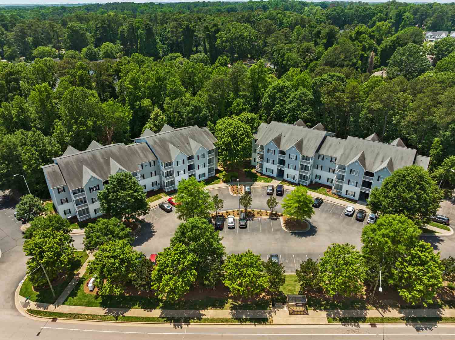 Blue hill top view the building and parking lot surrounded by trees all around